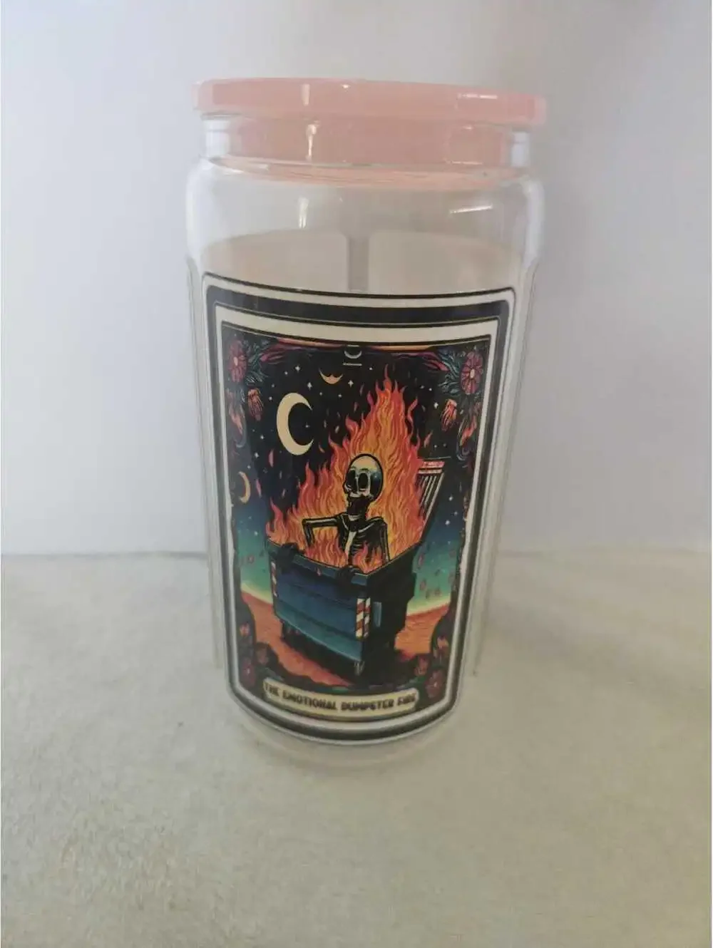 16 oz glass cup with acrylic Lid. Featuring skeletons and flowers.